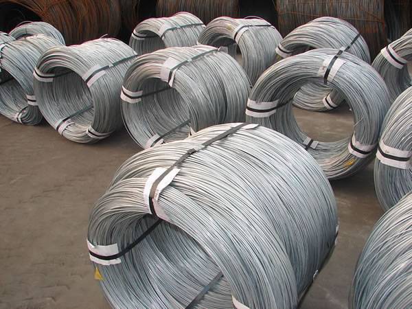 Several rolls of galvanized steel wires on the ground.