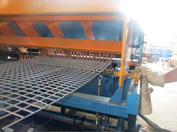 A machine is welding the welded mesh panels.